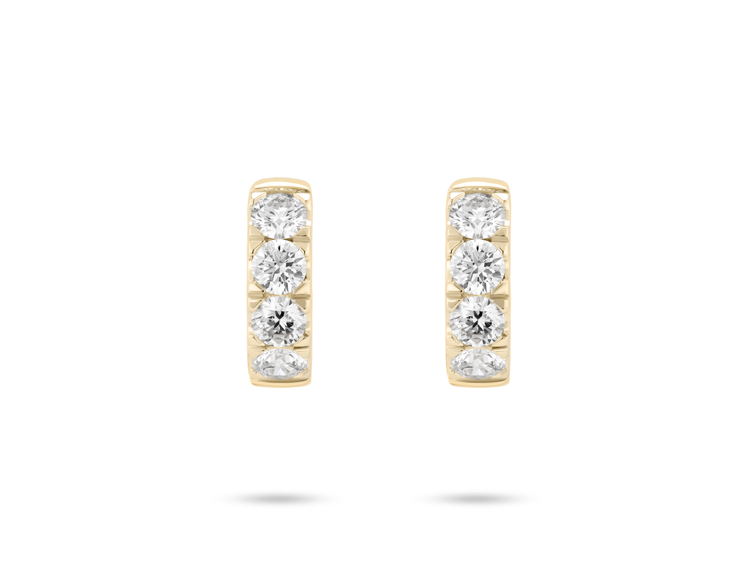 Front view of 0.8 carat total weight pavé huggie hoops in 14k yellow gold